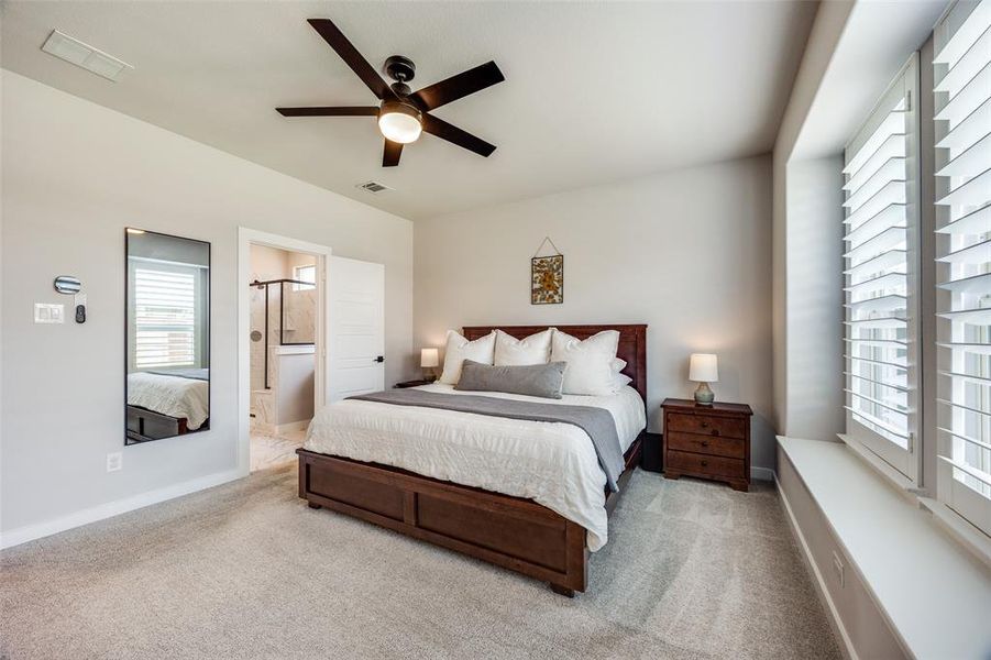 Primary Bedroom featuring carpet and ceiling fan