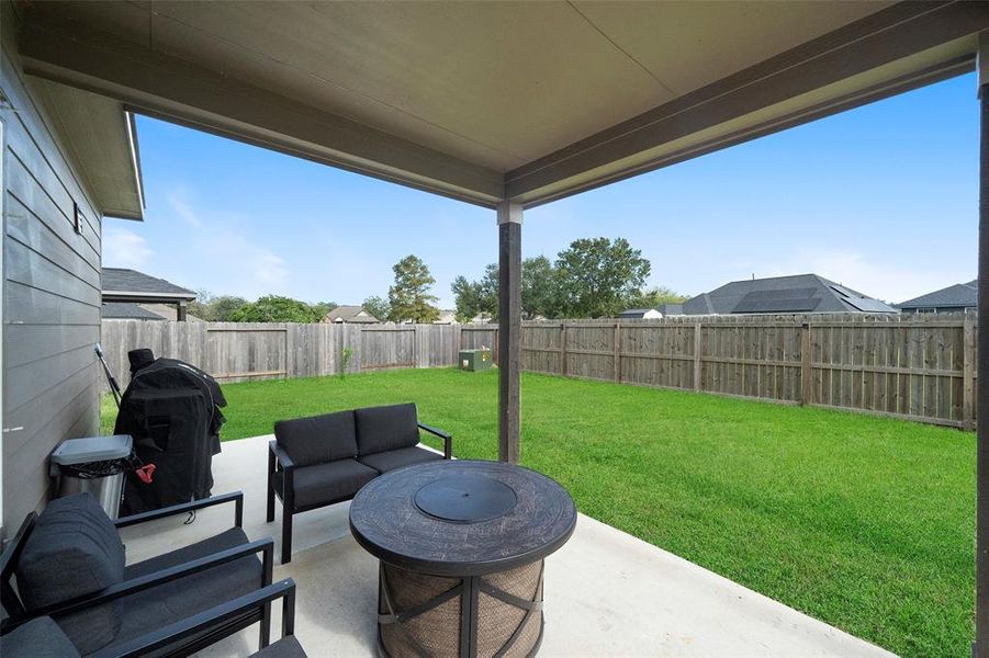 Covered patio with a beautiful view of the backyard.  PLENTY of room for a backyard pool!!