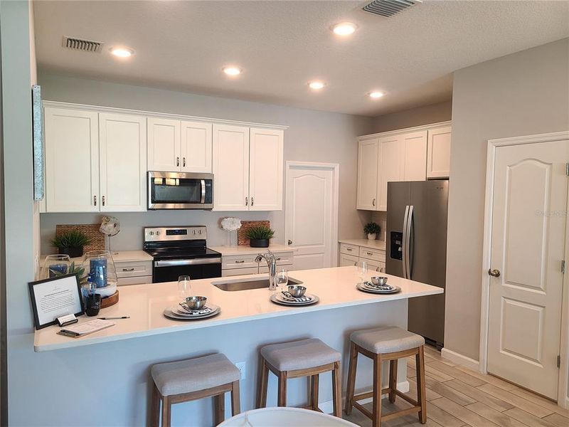 Open Kitchen with lots of Cabinets (staged model home photo)