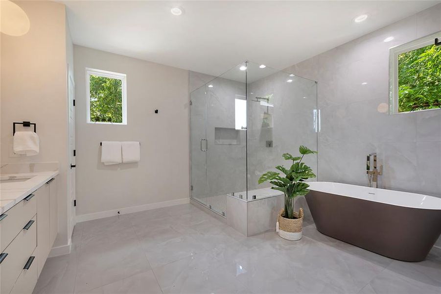 Primary Bathroom featuring vanity, tile patterned floors, and separate shower and tub