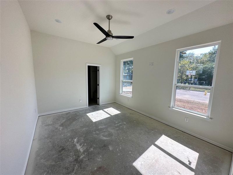 Unfurnished room featuring lofted ceiling and ceiling fan