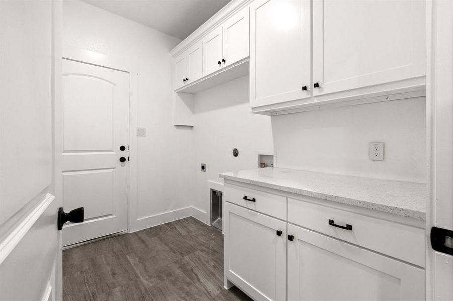 Laundry area featuring washer hookup, cabinets, dark wood-type flooring, and electric dryer hookup