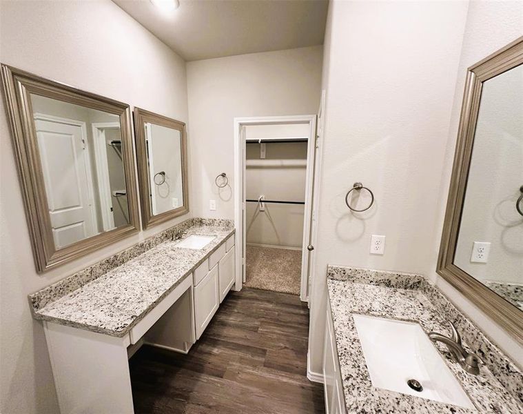 Her sink has convenient knee space, double framed mirrors, granite counters!