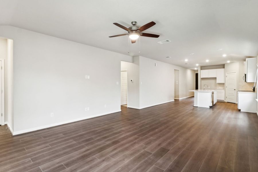 Dining room and kitchen in the Hughes floorplan at a Meritage Homes community.