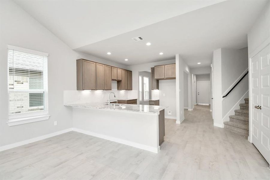 Discover another perspective of this beautiful kitchen! Sample photo of completed home with similar floor plan. Actual colors and selections may vary.