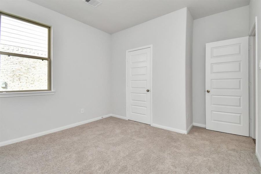 Generously sized secondary bedrooms featuring spacious closets, soft and inviting carpeting underfoot and large windows allowing plenty of natural light.