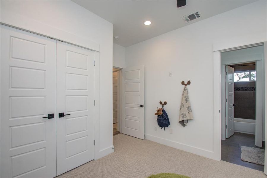 This secondary bedroom has a large closet! Model home photos - FINISHES AND LAYOUT MAY VARY! Ceiling fans are NOT INCLUDED!