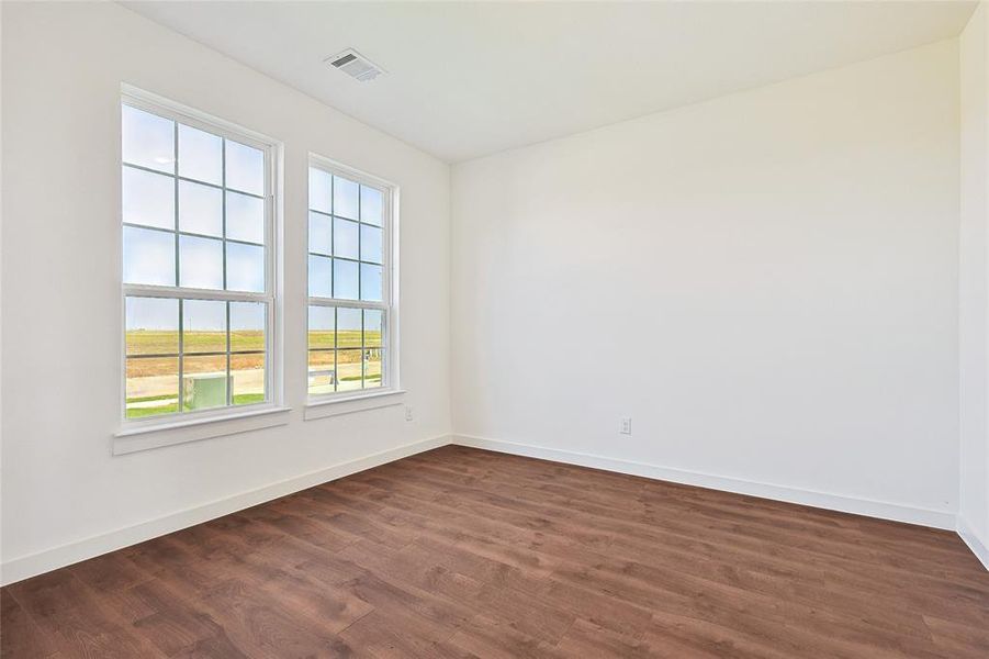 Spare room with dark wood-type flooring