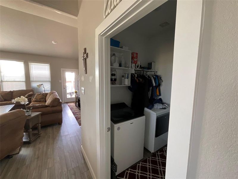 Laundry area featuring hardwood / wood-style floors