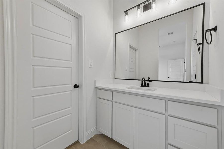 Bathroom featuring vanity and tile floors