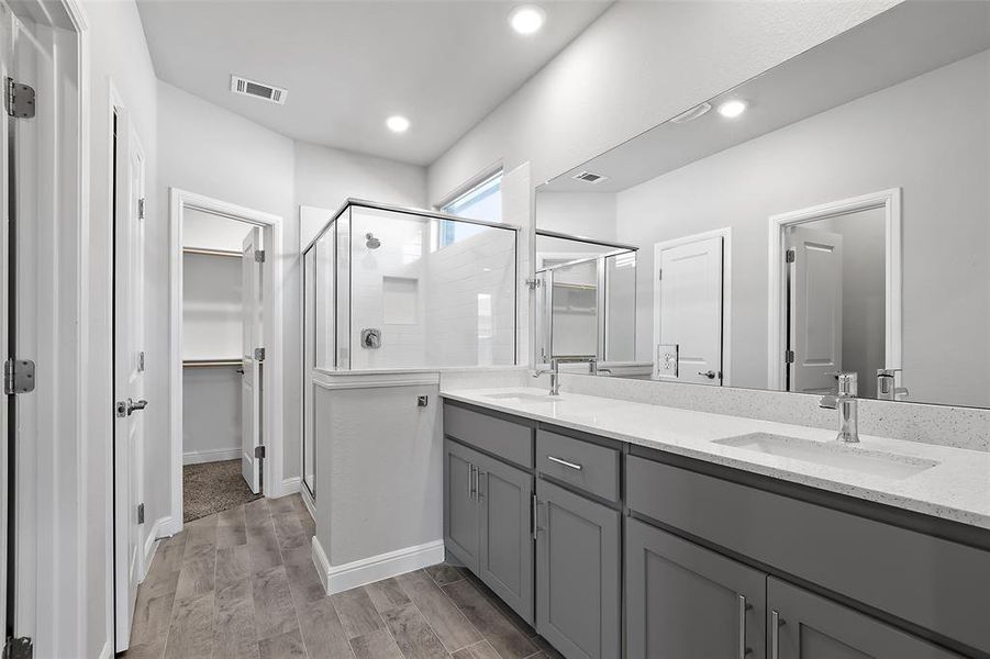 Bathroom with vanity, hardwood / wood-style floors, and walk in shower