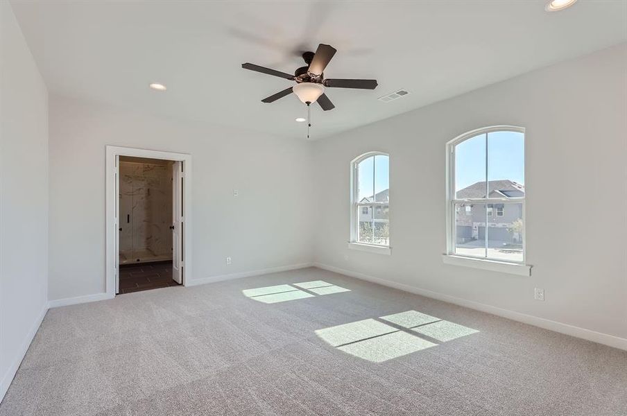 Spare room featuring carpet floors and ceiling fan