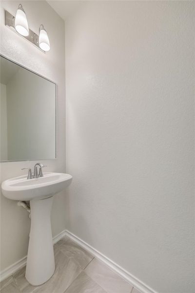 Half bath has pedestal sink