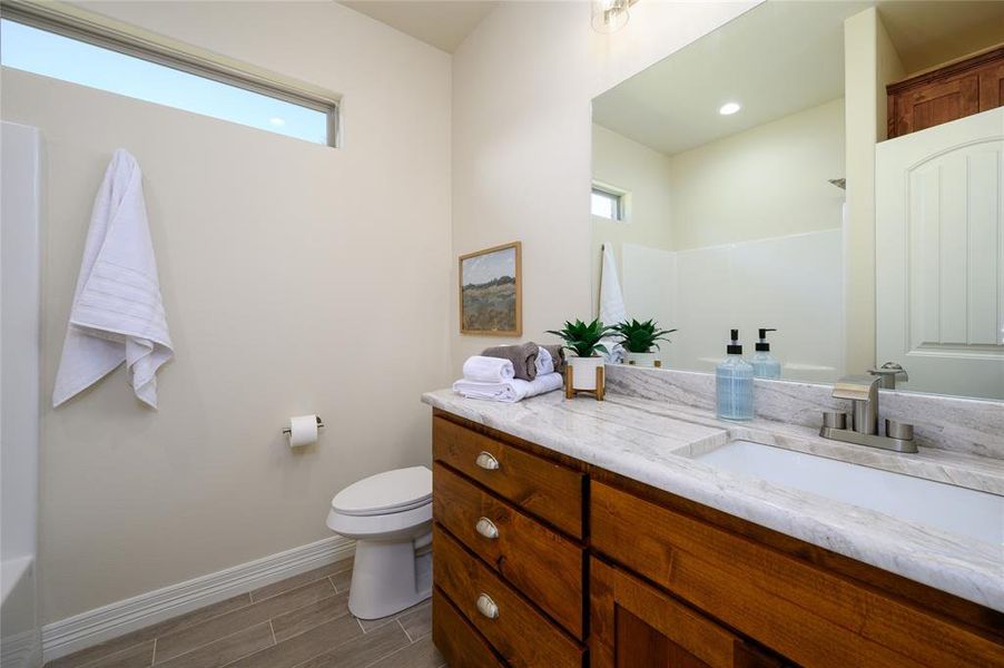 Bathroom with vanity, toilet, and a shower