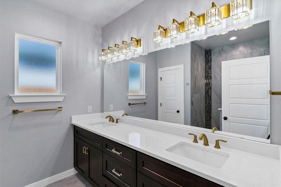 Bathroom with tiled shower and vanity