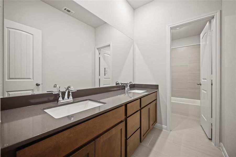 Welcome to the second bathroom of this charming home, designed with both functionality and style in mind.