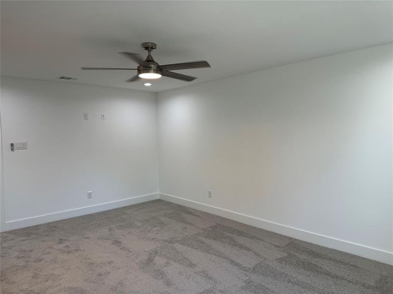 Unfurnished room with ceiling fan and carpet floors