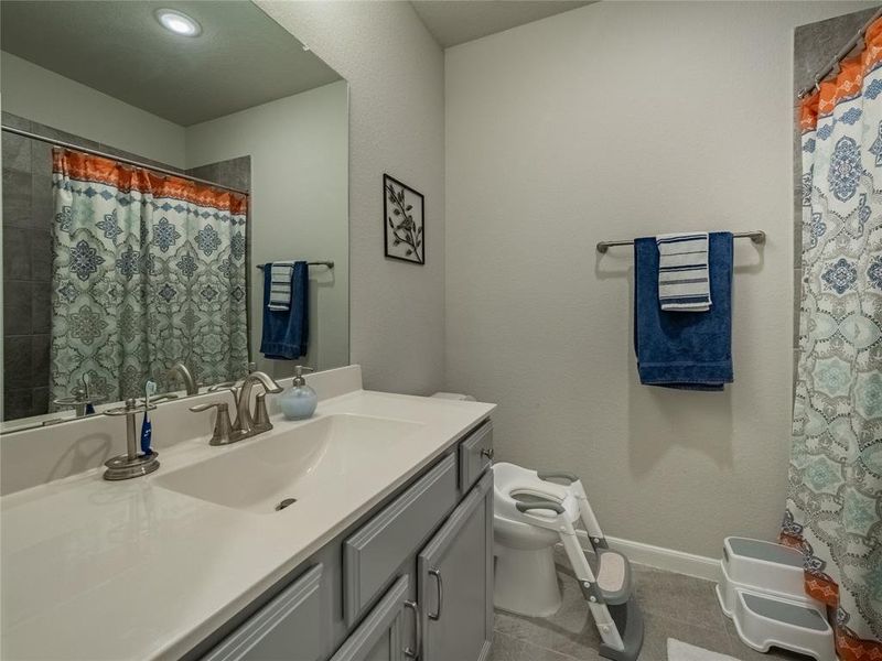 3rd bath room with granite counter tops and shower tub combo