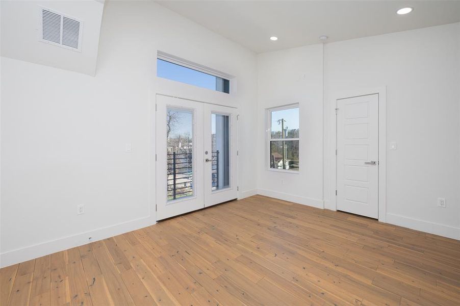 Spare room with hardwood / wood-style flooring and french doors