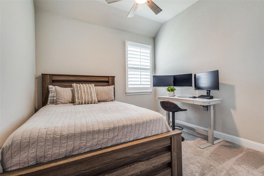 Bedroom featuring ceiling fan and lofted ceiling