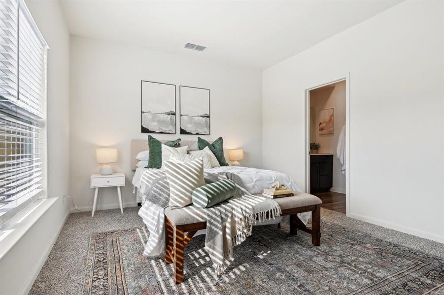 Carpeted bedroom with connected bathroom