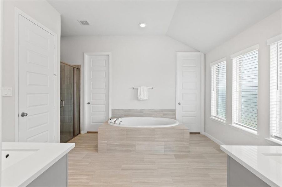 The master bathroom offers a luxurious experience with a separate tub and shower, perfect for relaxation.