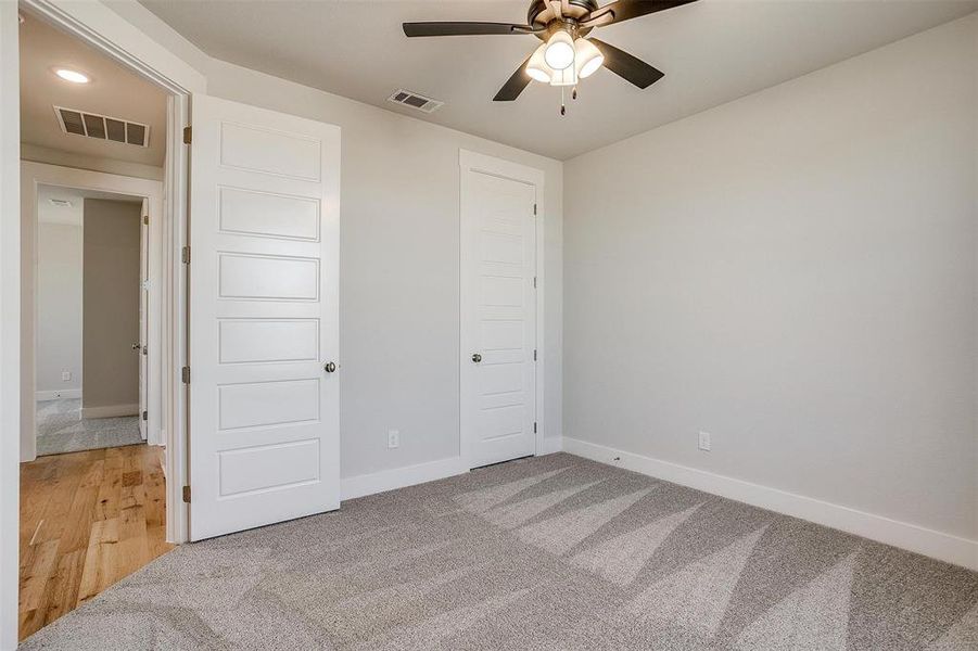 Unfurnished bedroom featuring wood-type flooring and ceiling fan