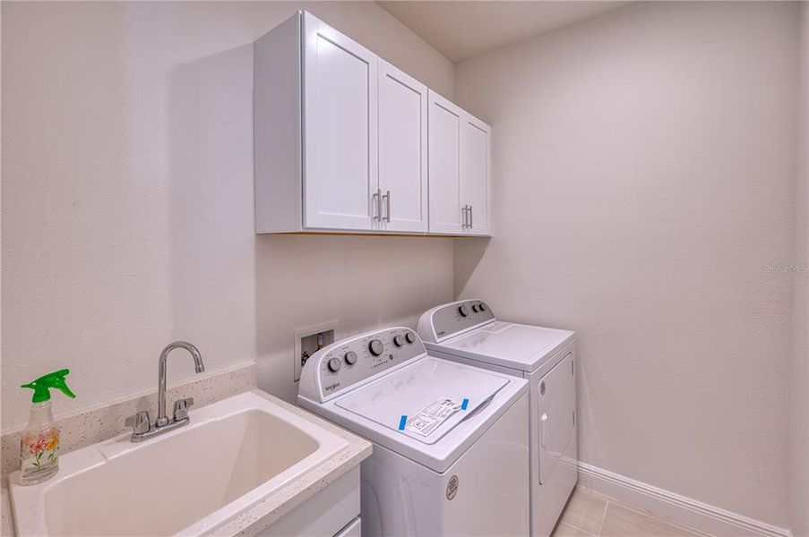 Laundry Room: with washer, dryer, utility sink and storage cabinetry.