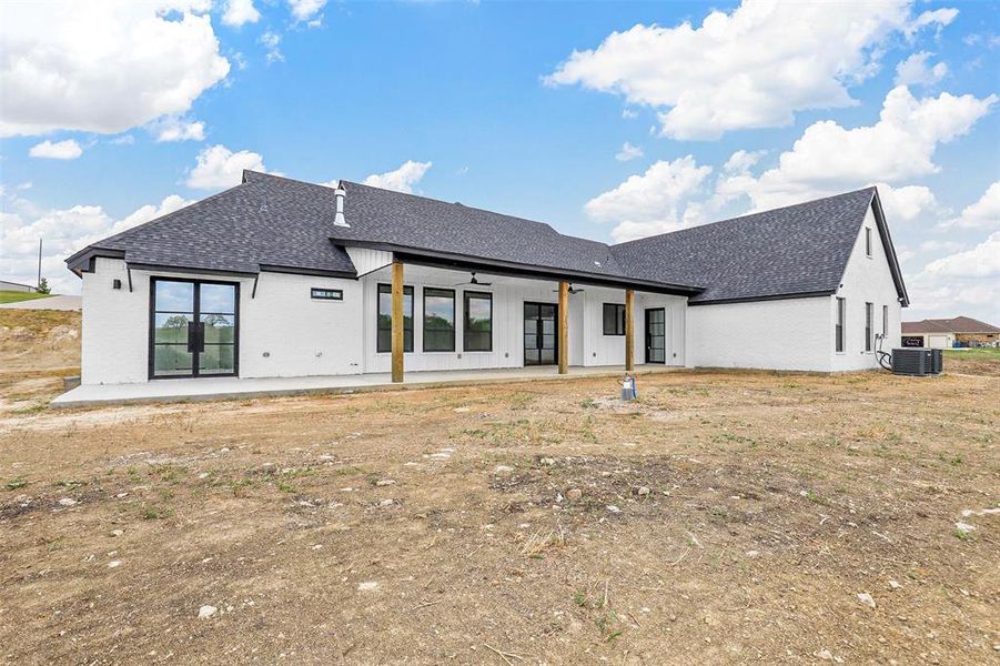 Back of property with a patio and central air condition unit