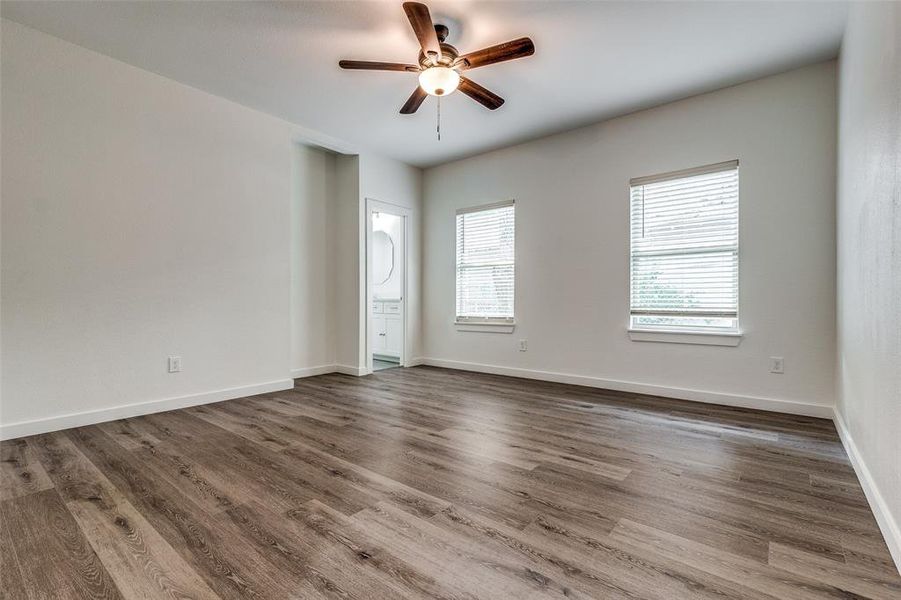 Unfurnished room with ceiling fan and hardwood / wood-style flooring