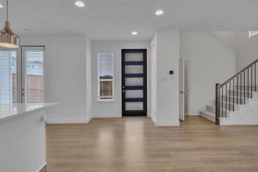 Foyer with light hardwood / wood-style flooring and french doors