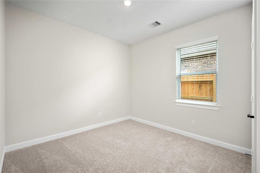 The second bedroom is spacious, has a closet for storage and carpet for comfort and style. This is the perfect space for a bedroom, craft room or office space.