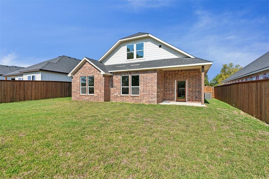 Back of property with a yard and a patio