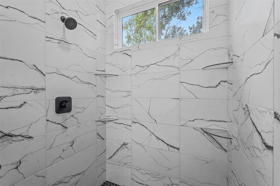 Bathroom featuring tiled shower