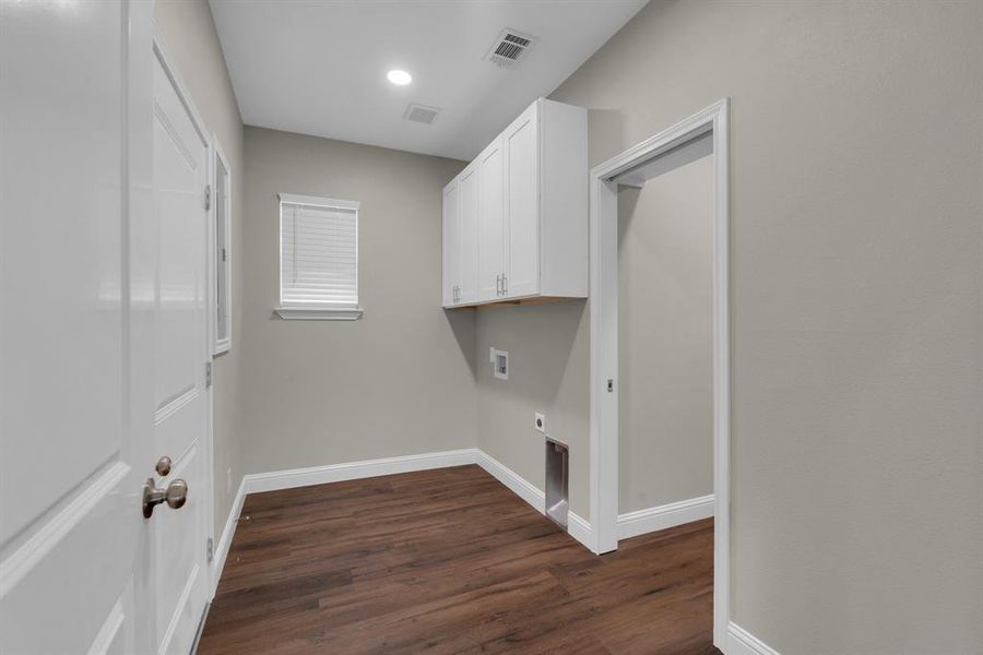 Washroom with washer hookup, dark wood-type flooring, and electric dryer hookup