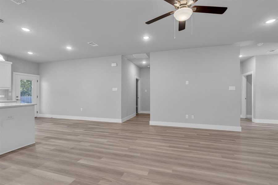 Unfurnished living room featuring light hardwood / wood-style flooring and ceiling fan