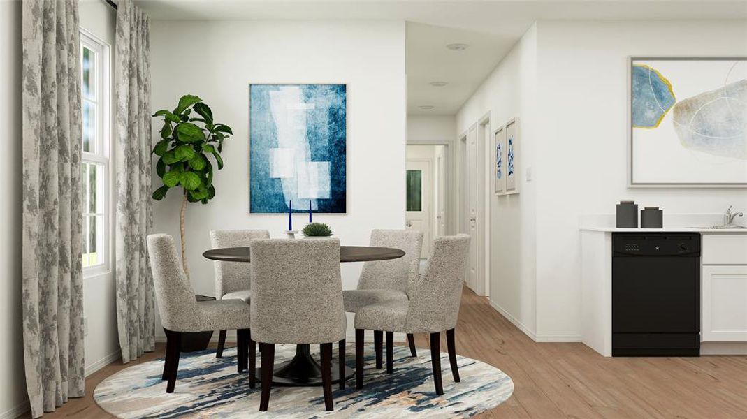 Dining space with light hardwood / wood-style flooring and sink