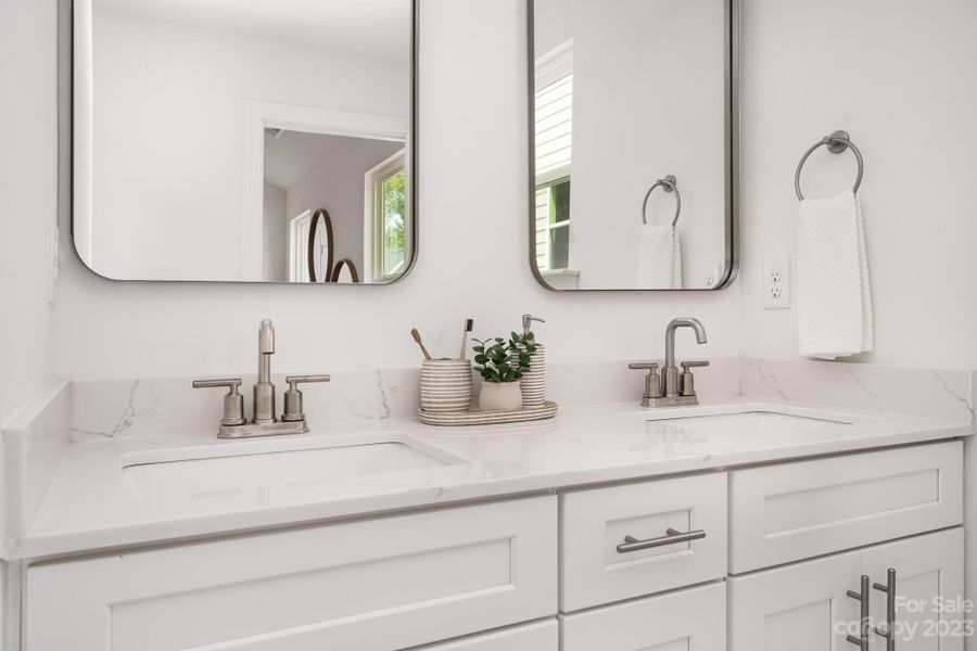 Representative Photo. Double vanity with dovetail cabinetry and quartz countertops