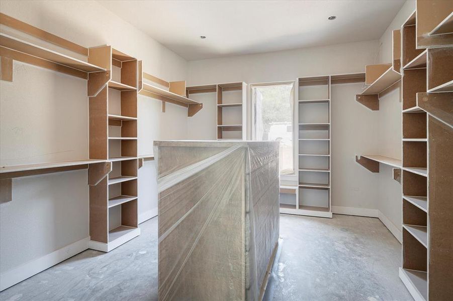 Spacious Closet in Owner's Retreat, off of the Ensuite has built-ins and window for natural light.