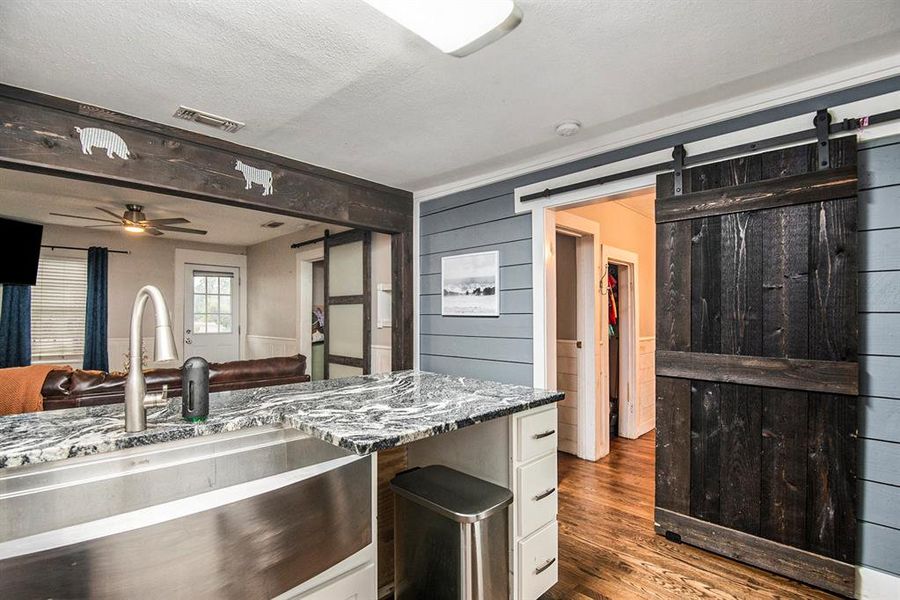 Stainless steel appliances and farm sink in kitchen