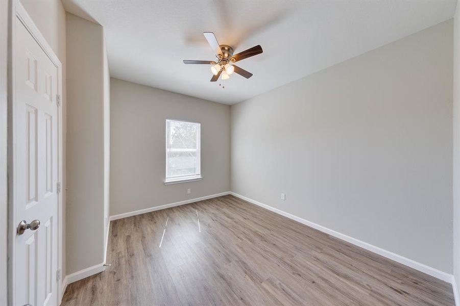 This bedroom is enhanced by a beautiful ceiling fan, offering both style and comfort. The fan not only adds a touch of elegance but also ensures a cool and relaxing atmosphere, perfect for restful nights.