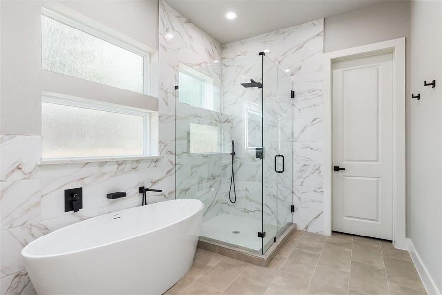 The soaking tub and frameless glass shower give you luxurious options for your daily routine