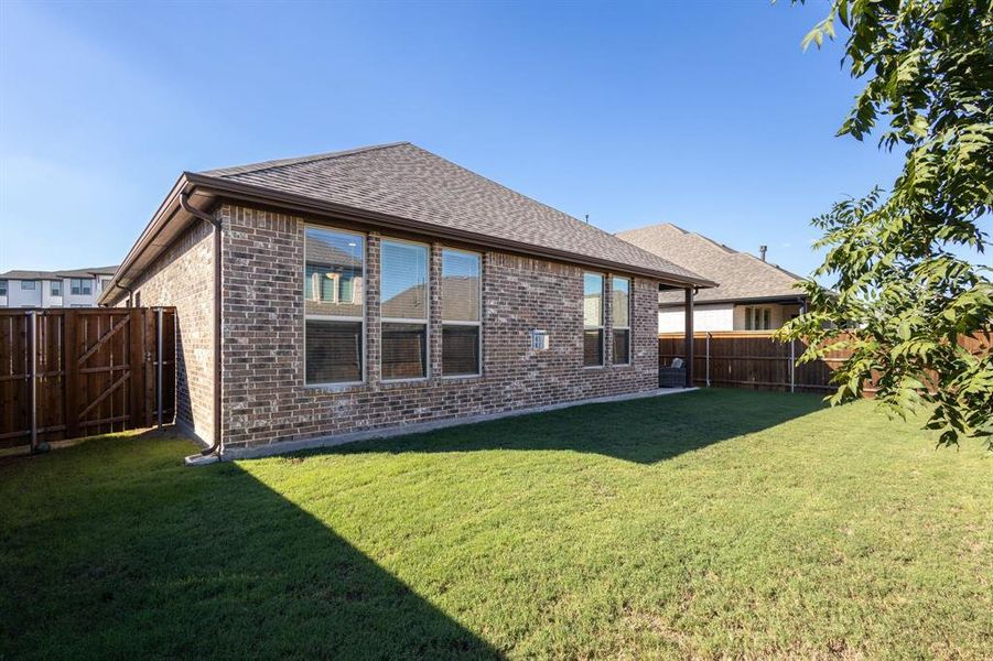 Back of house featuring a yard