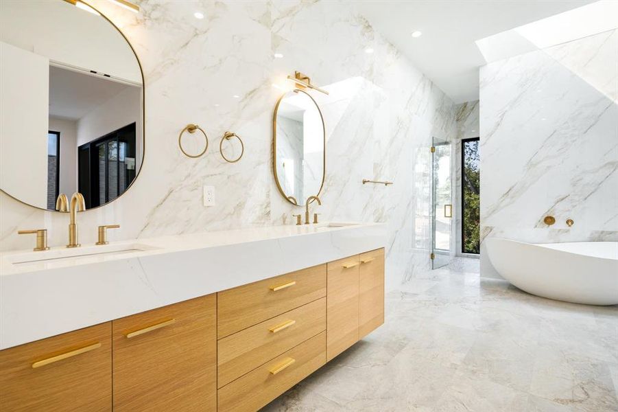 Bathroom featuring a tub, tile walls, and vanity