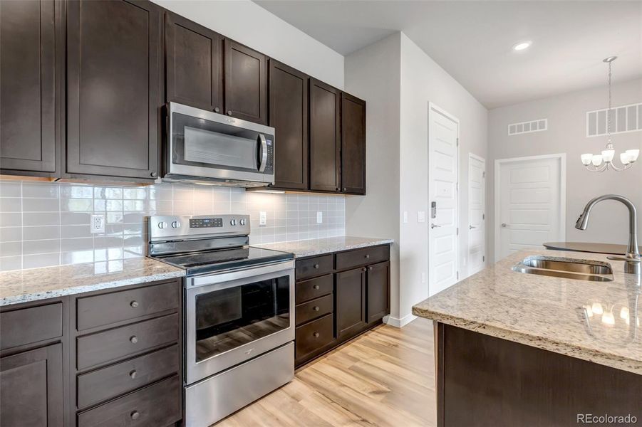 Granite Countertops, Light Gray Subway Tile, Stainless Steel Appliances