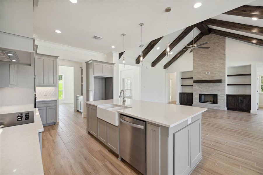 Kitchen with dishwasher, vaulted ceiling with beams, sink, and gray cabinets