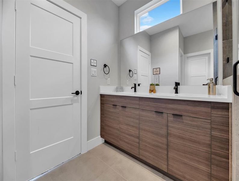 Quartz countertops, and natural light make this bathroom a stunner.