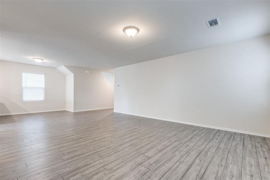 Empty room with light hardwood / wood-style floors