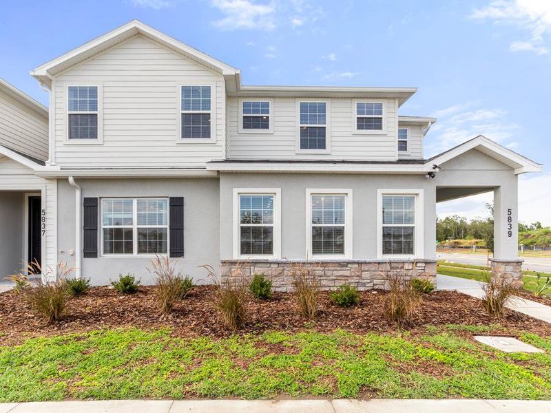 Your new end-unit townhome in St. Could, FL has gorgeous curb appeal - Mariposa townhome by Highland Homes