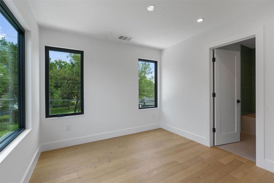 Bedroom #2 has an abundance of natural lighting and an ensuite bath.